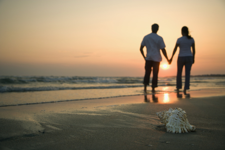 Man and Woman on beach holding hands